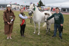 Sarah Conway, (Judge Horse Classes) with the Josie Kerin's Perpetual Cup for Champion Connemara of Show  (sponsored by Ballyhaunis Plant Hire) pictured with Rachel Byrne (granddaughter of Jarlath Grogan, Bekan Claremorris) and Mark Byrne, Tuam. Photo © Michael Donnelly