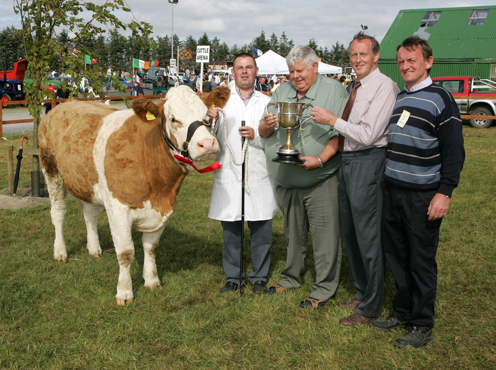 Martin Feeney, Ballygawley, Co Sligo is presented with the Parish Cup by PJ Timlin (steward) Michael Fox, Tullamore, (judge) and Colm Kitching (steward) at the 88th Claremorris Agricultural Show for best Continental X heifer to breed a Continental Calf, (Class 73).   Photo: © Michael Donnelly