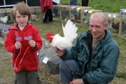 John Kenneth Dowling, Crossmolina holding his red rosette for his Bantan Cock, at the 88th Claremorris Agricultural Show, pictured with his dad John Dowling. Photo: © Michael Donnelly